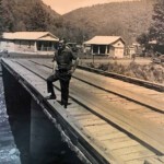 Photo of Ralph Thomas Grimmett (1927-1984) on the Kistler Bridge on Buffalo Creek outside of Man in Logan County, WV.