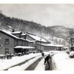 Sharples 1942. Charles Adams throwing the snowball with Billy Cook behind him. The big building on the left is the YMCA. Photo by Tom Gayhart and shared courtesy of Peggy Huff. Sharples 1942