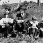 "The picture was among those kept by Peter Flanigan who was site superintendent for sinking the Dehue Mine shaft and slope during 1917. Peter’s notation on back of the picture identifies: October 1, 1916 near Uniontown, Pa. Left – right GP Harvey holding daughter, Pauline Harvey, Peter Flanigan, Mary Harvey, and Sicely Harvey. GP’s wife, Jane took the picture. GP and Peter were doing mine shaft work near Uniontown during 1916 before coming to Dehue. GP’s family resided in one of the camp houses while they were still under construction. Peter Flanigan and some of the other workers lived in a “batching shanty” at the shaft and slope site." Courtesy of Richard Flanigan. GP Harvey holding daughter Pauline Harvey, Peter Flanigan, Mary Harvey, and Sicely Harvey 1916. Courtesy of Richard Flanigan.