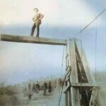 Sign painter Jim Singleton on the Godby Bridge over the Guyan River. Was just before Highland Cemetery. Courtesy of Kenneth Singleton. 91646 Jim Singleton on the Godby Bridge, Logan County, West Virginia