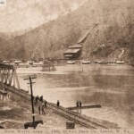 Postcard showing the flooding of the Mt. Gay area postmarked Logan May 30, 1908. Message on the back: “Here is a view of Gay Town one mile from Logan. See how the flood completely surrounded it. Sure was one of the worst floods for years in this county. We were shut off from every place for 15 days. With love to all, write soon. Raymond”. Image 78915. Mount Gay, Logan County, WV April 1, 1908