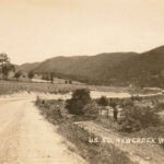 Real photo postcard veiw of US Route 50 at New Creek, WV. US Route 50 New Creek, WV