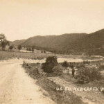 Real photo postcard veiw of US Route 50 at New Creek, WV. US Route 50 New Creek, WV