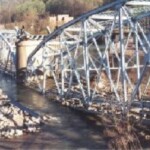 The Blue Bridge comes down on April 10, 1999 at 6:30am. The Logan General Hospital looms in the background. Blue Bridge Comes Down