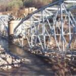 The Blue Bridge comes down on April 10, 1999 at 6:30am. The Logan General Hospital looms in the background. Blue Bridge Comes Down