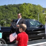 Delegate Rupert “Rupie” Phillips Jr. reading of the resolution and Danny's six year old grandson, Nathan holding the flag. danny-m-greene-bridge-5