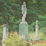 Hatfield Family Graveyard postcard courtesy of Christine Gray. Photo by Charles L. Elkins. “In 1880, a Hatfield had a difference of opinion with a McCoy over a wild pig and $1.75. This developed into a feud which became a southern Appalachian folklore classic. Feuding became a family tradition as portrayed in a verse from the ballad <em>‘Jim Hatfield ‘s Son’: <br />
To never fail the Hatfield clan, <br />
For he was born to fight; <br />
To never be afraid to die, <br />
And shoot McCoys on sight.”</em> Hatfield Family Graveyard