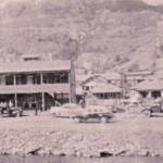 This photo was take by my Dad (Brady Thompson) in about 1949. He was driving through Mud Fork and saw a "big fight going on" and snapped this photo. Buster Dingess owned the apartment building. Logan County, WV about 1949