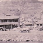 This photo was take by my Dad (Brady Thompson) in about 1949. He was driving through Mud Fork and saw a "big fight going on" and snapped this photo. Buster Dingess owned the apartment building. Logan County, WV about 1949