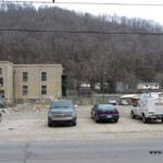 The empty lot where Logan High School and later the East Jr. High School stood. On the left is the old Logan Grade School. Photo taken 3-25-2014. Old LHS Empty Lot, Logan, WV