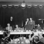 ROBERT BYRD CAMPAIGNING FOR OFFICE<br />
Ray Watts (former sheriff) behind suitcase, Lester "Bus" Perry, standing behind him, (now Senator) Robert Byrd to right of Watts, man with cigar, Judge C.C. Chambers, man standing behind Chambers is (former sheriff) Grover Combs. Picture courtesy of Ed Baldwin's son, Ralph. Robert Byrd Campaigning Logan WV