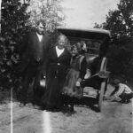 Scott Taylor, Alice Taylor and Elizabeth Taylor during a trip to KY in 1921. It may be Ed Taylor fixing the flat tire. Scott Taylor, Alice Taylor and Elizabeth Taylor during a trip to KY in 1921. It may be Ed Taylor fixing the flat tire.