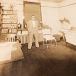Courtesy of Leslie Rivers. She writes: “Dr. Moore in the late 1920s in his Stirrat office. Note the desk. Cap Hatfield was sitting at this desk when Dr. Moore told him he had a fatal brain tumor after examining him. Dr. Moore referred him to Johns Hopkins Hospital in Baltimore for further confirmation of his diagnosis. Cap opted for surgery to remove the tumor. He went into surgery at 8 am and was dead by 11 am and in the autopsy theater. The tumor was massive and the cancer had metastasized to most of his internal organs. The autopsies found old scar tissue from a bullet wound in his sigmoid colon. They didn't remove the bullet as it was not the cause of death. Dr. Moore and Cap Hatfield had been loyal and confidential friends until Cap's death in 1930. It was not until the late 1950s that Dr. Moore revealed how close their friendship had been. In the 1990s, Jean Hatfield wrote in one of her several letters to me that it was a well-known fact that Dr. Moore was the Hatfield Family physician. The autopsy report is on display in the Pikeville KY Museum.“ Image 764926. Dr. Moore in the late 1920s in his Stirrat Office, Logan County, WV.