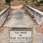 The bridge to Cap Hatfield's home. The plaque at the bottom of the photo is the plaque on the bottom-right corner of the bridge, courtesy of Dwight Williamson. (Digitally restored).<a href="https://loganwv.us/cap-hatfield-led-an-interesting-life/">Cap Hatfield led an Interesting Life</a> Photo of the bridge to Cap Hatfield's home.